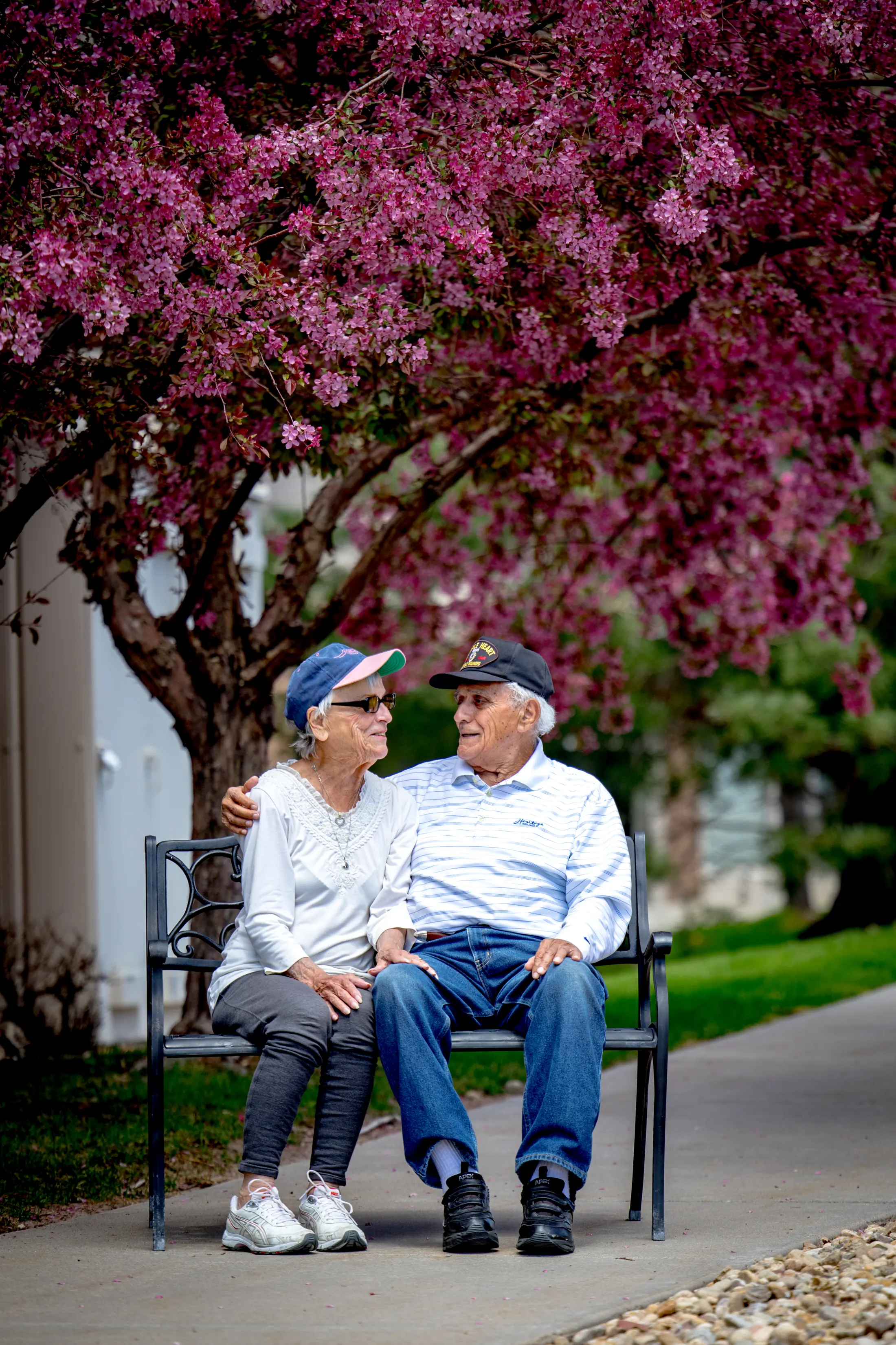 Bear Creek residents relaxing together on a courtyard bench.