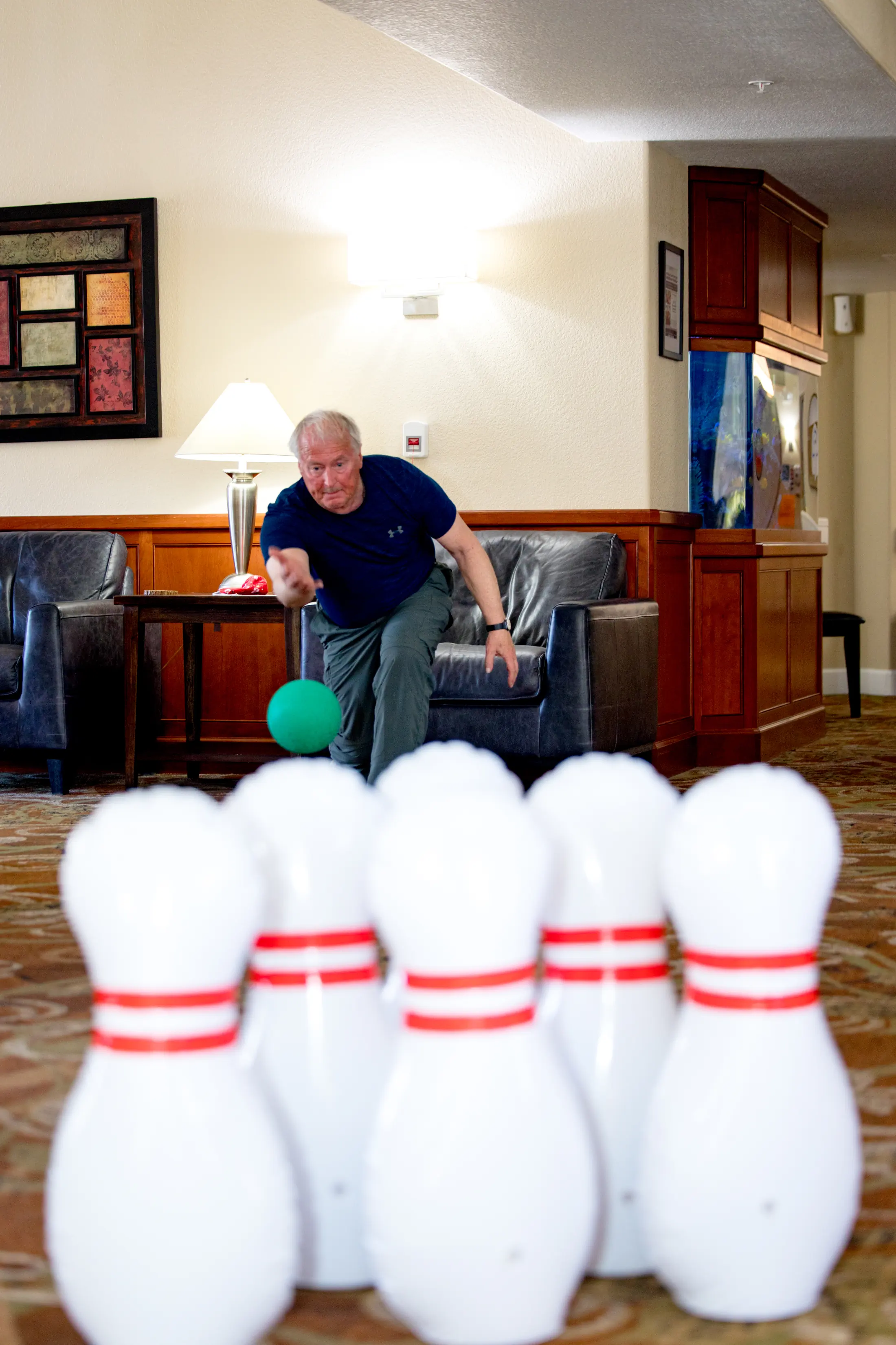 Bear Creek resident playing bowling in a community activity space.